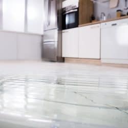 Close-up Photo Of Flooded Floor In Kitchen From Water Leak